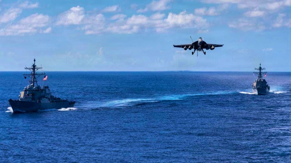 HANDOUT - In this photo provided by the Pentagon Press Office, the Arleigh Burke-class guided-missile destroyers USS Mahan (l, DDG 72) and USS Bainbridge (DDG 96) sail in formation as an F/A-18 Super Hornet from Carrier Air Wing Eight prepares to land on the aircraft carrier USS Gerald R. Ford (CVN 78). Photo: Petty Officer 2nd Class Triniti/U.S. Pentagon/dpa - ATTENTION: For editorial use only and only with full attribution to the above credit
