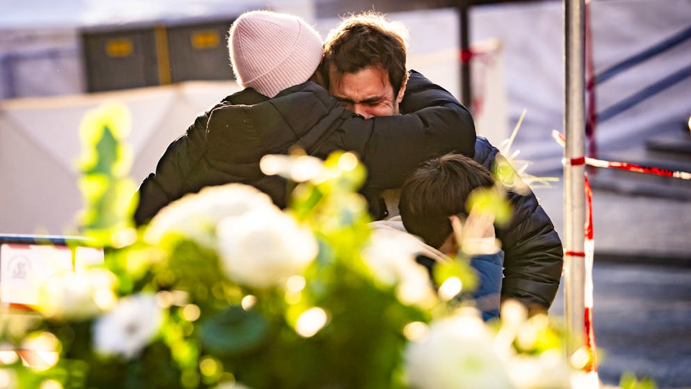 Menschen weinen nach Brandkatastrophe in der Neujahrsnacht vor der Bar Le Constellation in Crans-Montana VS.
