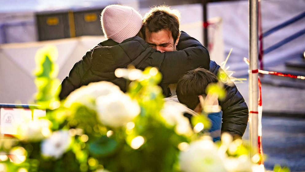 Persone in lacrime davanti al bar Le Constellation di Crans-Montana VS dopo l'incendio della notte di Capodanno.