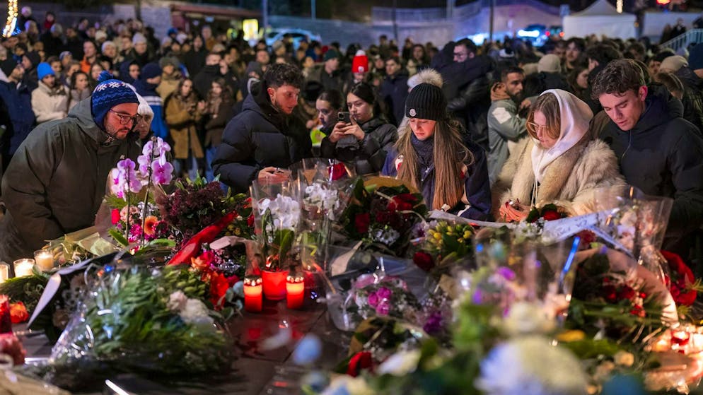 Hundreds of mourners gather in Crans-Montana on Thursday after the fire disaster.