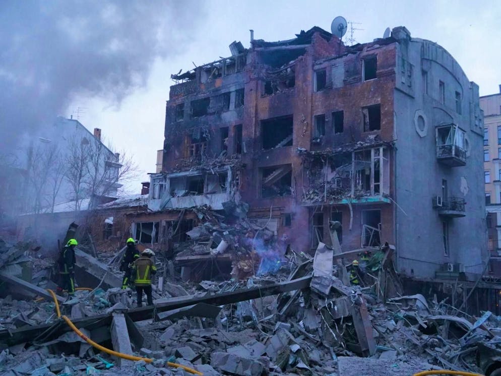 Rescue workers extinguish a fire after a Russian missile attack.
