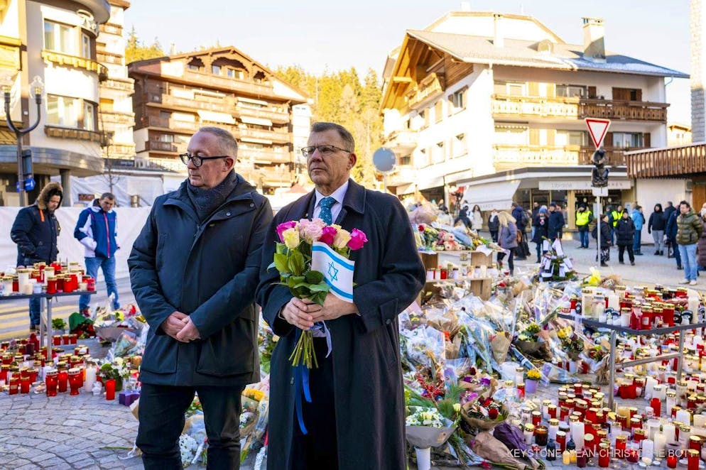 Tibor Schlosser (right), the Israeli ambassador to Switzerland and Liechtenstein, pays his respects to the victims alongside Nicolas Feraud, the mayor of Crans-Montana, after the fire at the "Le Constellation" bar and lounge on Sunday, 4 January 2026.