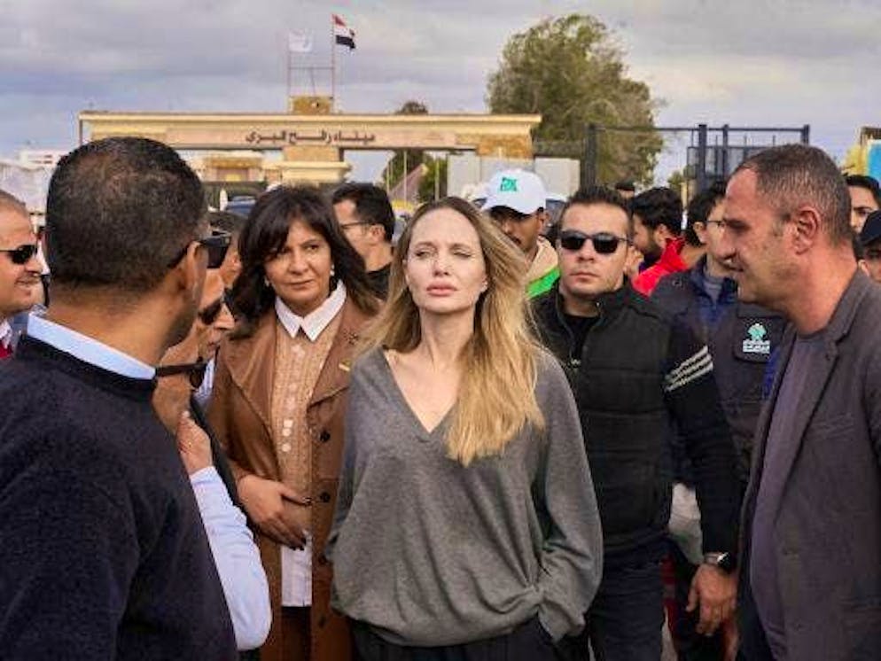 The American actress and film producer Angelina Jolie (M) stands at the Rafah border crossing during her visit.