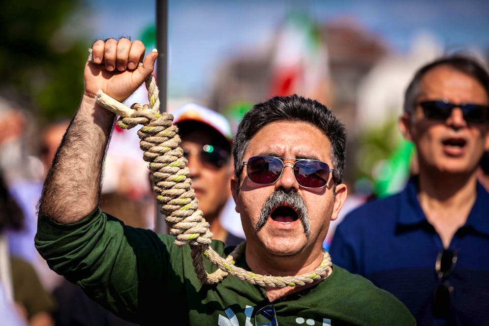 A man symbolically carries a gallows rope during a global day of protest against executions in Iran in 2023.