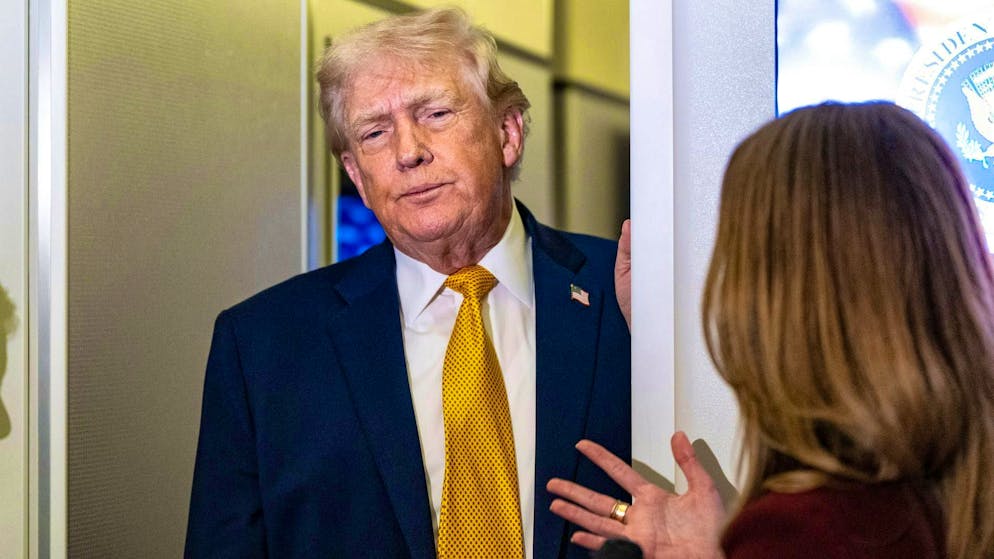 US President Donald Trump talking to journalists on board Air Force One on the way to Washington.