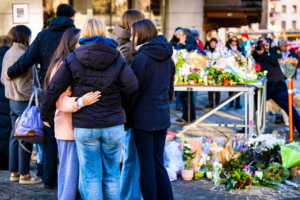 People gather in Crans-Montana to remember the victims of the fire disaster. On Friday, Switzerland will hold a nationwide minute's silence at the same time as the memorial service.