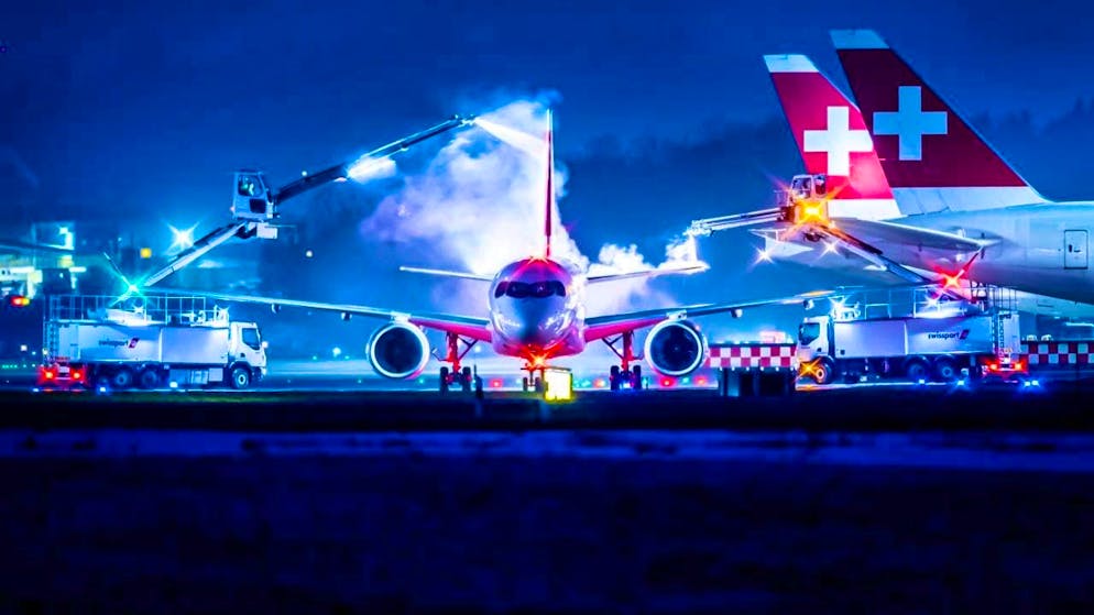 The deicing teams remove snow and ice from the wings of aircraft at Zurich Airport.