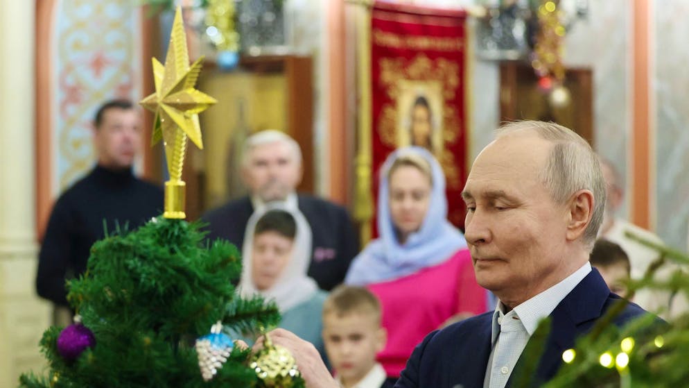 Der russische Präsident Wladimir Putin (r.) beim Weihnachtsgottesdienst in einer Kirche in Moskau.
