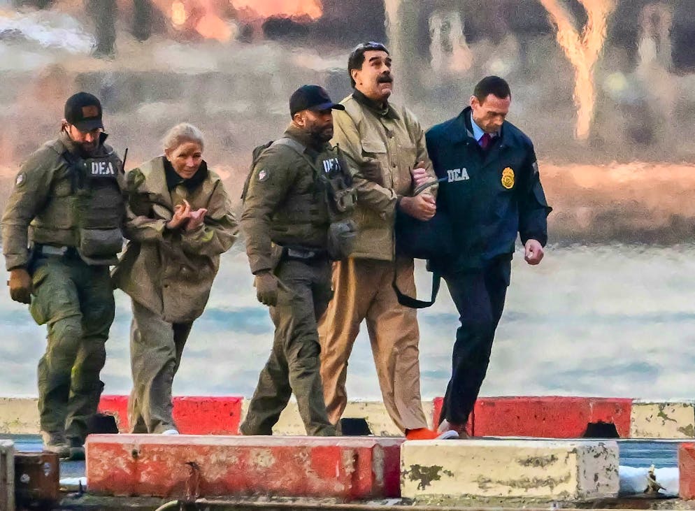Surrounded by heavily armed security forces, captured Venezuelan President Nicolas Maduro (2nd from right) and his wife Cilia Flores (2nd from left) arrive at the Wall Street Heliport in the New York borough of Manhattan.