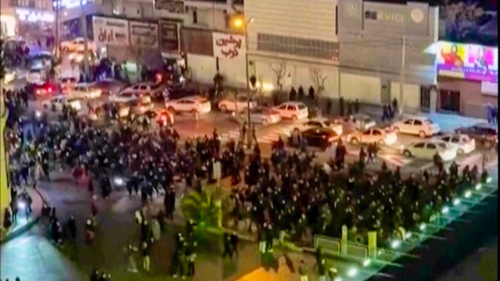 HANDOUT - This video still taken by a person not employed by the Associated Press and obtained by AP outside Iran shows people blocking an intersection during a protest. Photo: Uncredited/UGC/AP/dpa - ATTENTION: For editorial use only in connection with breaking news coverage over the next 48 hours and only with full credit to the above