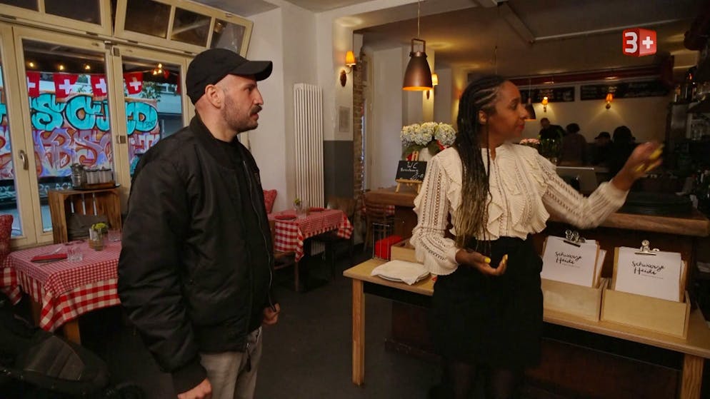 «Adieu Heimat» 2026: Die erste Folge. In Berlin trifft er auf Exil-Schweizerin Jennifer Mulinde-Schmid. Die Zürcherin lebt seit über 20 Jahren in der deutschen Metropole und ist eine erfolgreiche Gastronomin und Entertainerin. Sie will Sandro auf die Sprünge helfen.