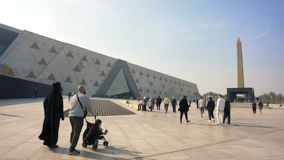 Die beeindruckende Kulisse des Grand Egyptian Museum (GEM) in Gizeh, dominiert von der monumentalen Fassade und dem davor thronenden hängenden Obelisken von Ramses II.