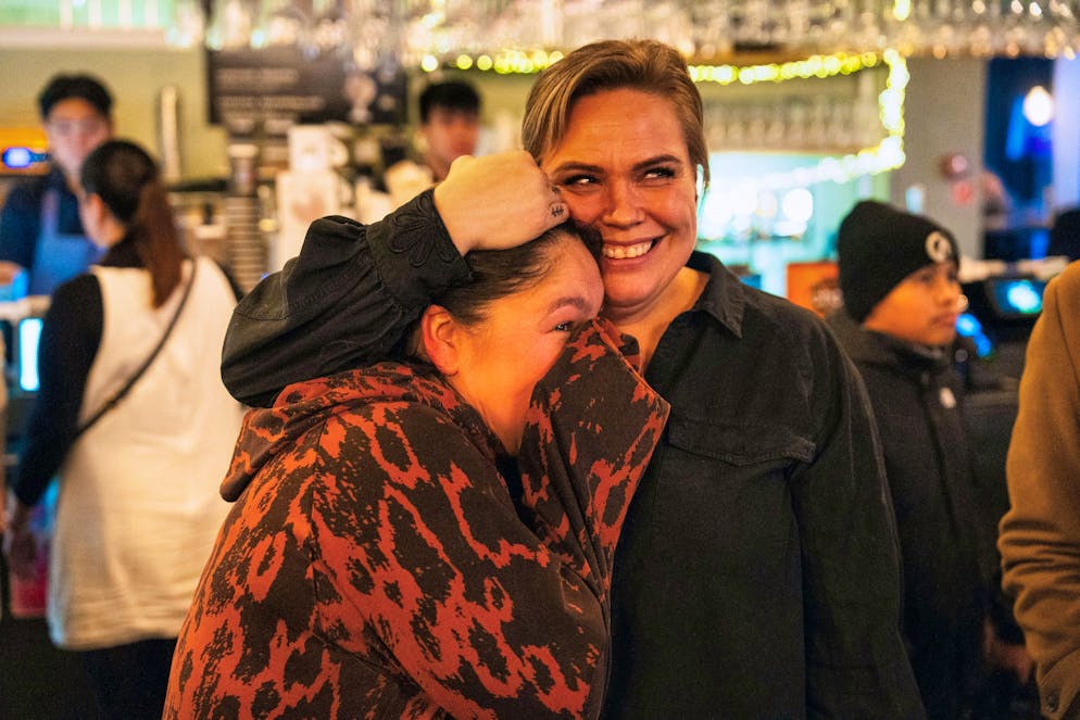 People watch the press conference of Greenland's Foreign Minister Vivian Motzfeldt and Danish Foreign Minister Lars Loekke Rasmussen on television in a restaurant in Nuuk after a meeting in Washington on the future of the island.
