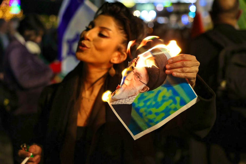 At a protest rally in Holon, Israel, a member of the Israeli-Iranian community burns a portrait of Iran's Supreme Leader Ali Khamenei.