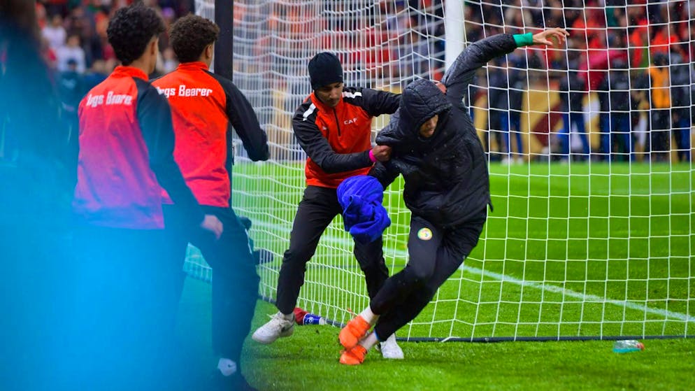 Senegal's substitute goalkeeper Yehvann Diouf defends himself against the ball boys.