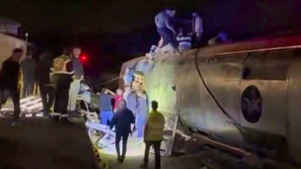 At least 21 dead in train crash in Spain - Gallery. Rescue workers investigate the derailed train.