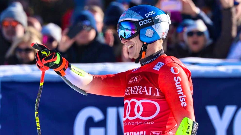 Marco Odermatt celebrates after crossing the finish line at the Super-G in Kitzbühel