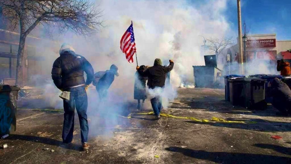 Federal immigration officials use tear gas after the shooting incident in Minneapolis.