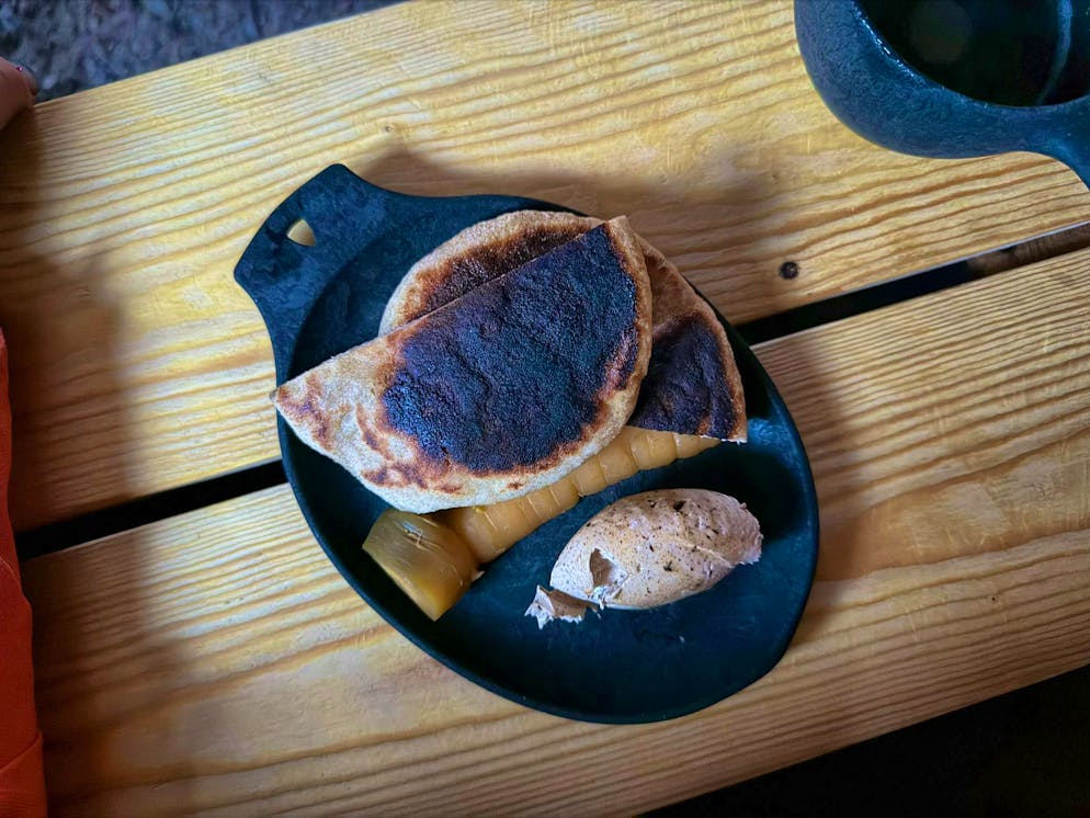 Press trip Finland. The bread is served with black garlic butter. Served with a pickled carrot.