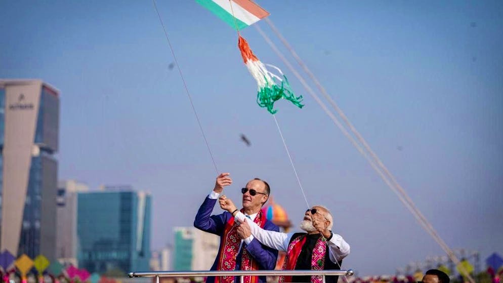 ARCHIVE - Narendra Modi (r), Prime Minister of India, and German Chancellor Friedrich Merz (CDU) visit a kite festival. Photo: Kay Nietfeld/dpa