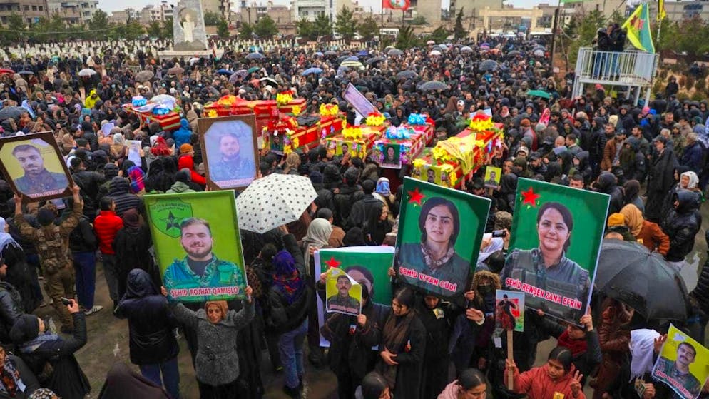 Mourners attend the funeral of fighters from the Kurdish-led Syrian Democratic Forces (SDF) who were killed in clashes with Syrian government forces earlier this month. Photo: Baderkhan Ahmad/AP/dpa