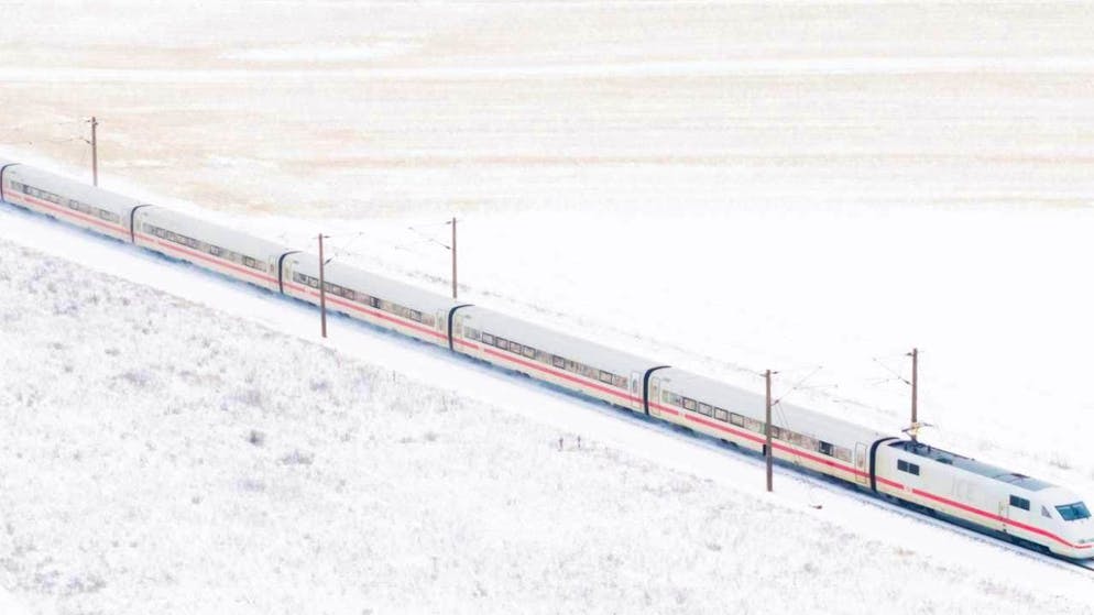 ARCHIVE - A Deutsche Bahn ICE train in a winter landscape. Photo: Julian Stratenschulte/dpa/Archivbild