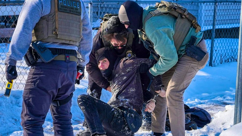 A man is arrested by federal agents in Minneapolis on Tuesday.