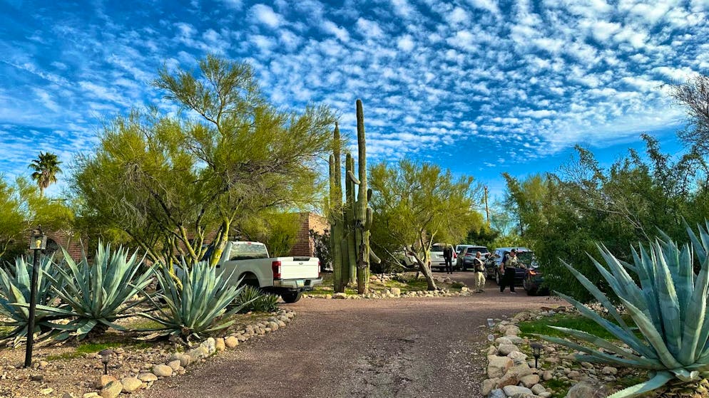 Police officers on the property of Nancy Guthrie, who was last seen last Saturday and reported missing the following day.