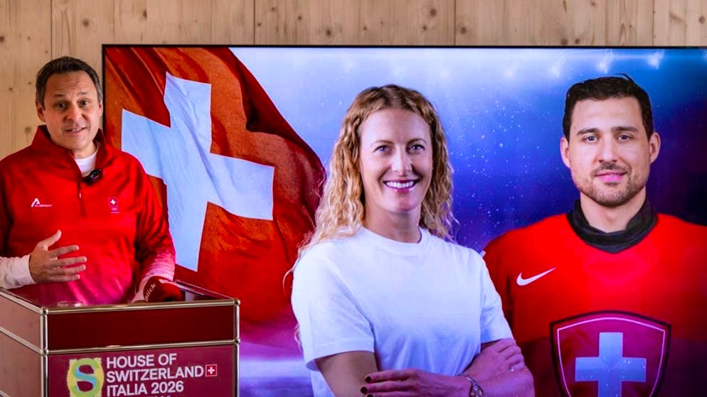 Head of the Swiss Olympic delegation Ralph Stöckli (left) presents the two Swiss flag bearers: ski cross athlete Fanny Smith, who is taking part in the Olympics for the fifth time, and national ice hockey player Nino Niederreiter