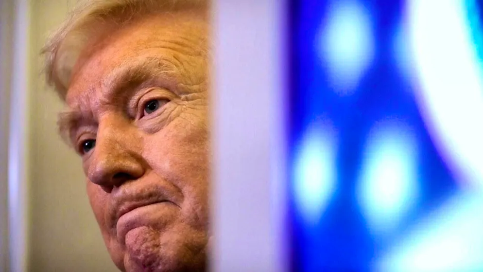 US President Donald Trump listens to a reporter's question as he flies aboard Air Force One from Joint Base Andrews to West Palm Beach. Photo: Mark Schiefelbein/AP/dpa