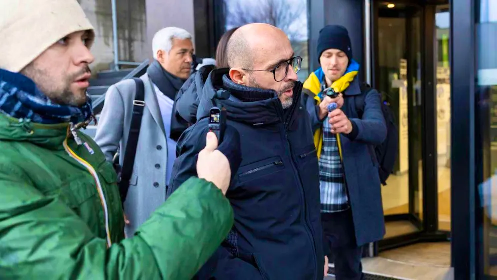 Bar owner Jacques Moretti (center) has to face questions from the victims' lawyers on Wednesday. He did not respond to questions from journalists.