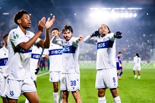 FC Lausanne-Sport's Gabriel Sigua, center, celebrates after scoring the 1:0 goal next to FC Lausanne-Sport's Enzo Kana-Biyik, left, and FC Lausanne-Sport's Theo Bair, right, during the League phase soccer matchday 6 of the UEFA Conference League between FC Lausanne-Sport, LS, and ACF Fiorentina at the stade de la Tuiliere stadium, in Lausanne, Switzerland, Thursday, December 18, 2025. (KEYSTONE/Jean-Christophe Bott)