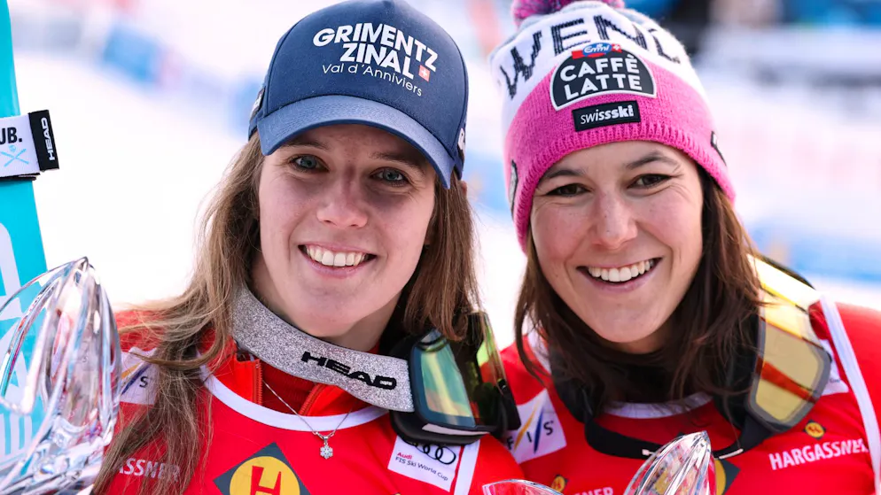 Switzerland's Camille Rast, left, poses with third placed Wendy Holdener after winning an alpine ski, women's World Cup slalom, in Kranjska Gora, Slovenia, Sunday, Jan. 4, 2026. (AP Photo/Marco Trovati)
