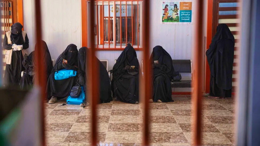 ARCHIVE - Women wait at a medical center in al-Hol camp, one of the detention centers where thousands of IS members and their families are held and which is now under the control of the Syrian government after the withdrawal of the Syrian Democratic Forces (SDF). Photo: Ghaith Alsayed/AP/dpa