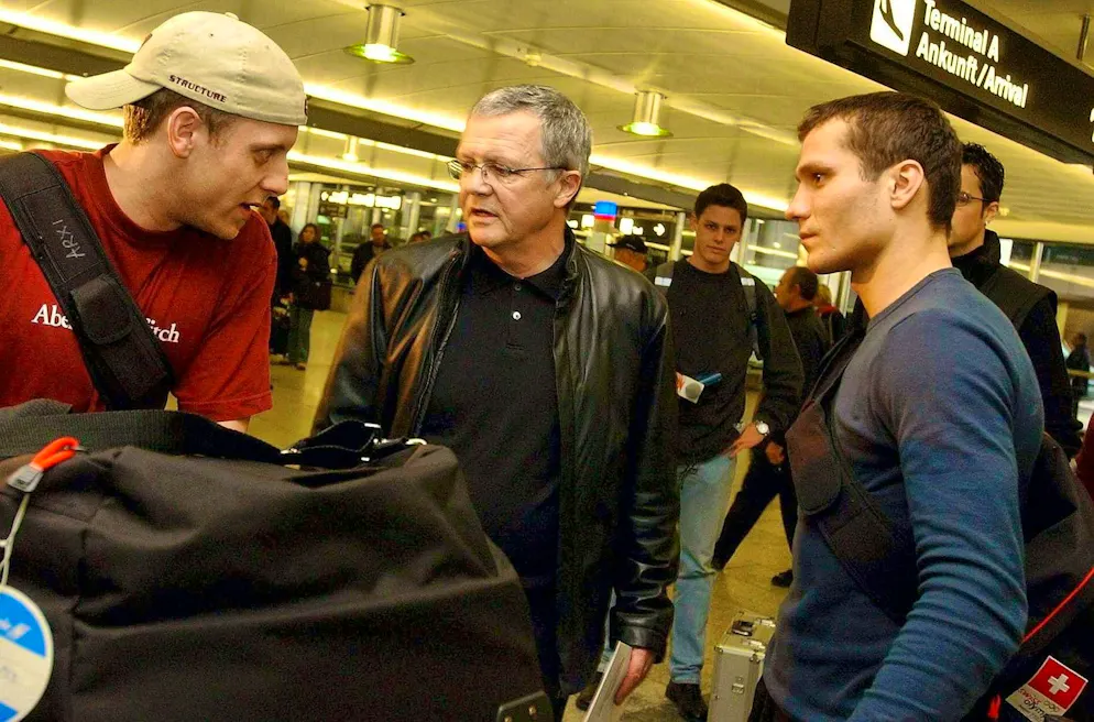 Reto von Arx, left, and Marcel Jenni, right, with their former manager Peter Dietrich, center, after their premature return from Salt Lake City.