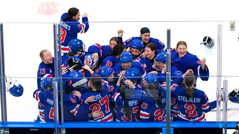 The Americans celebrate after beating Canada in overtime in the final.