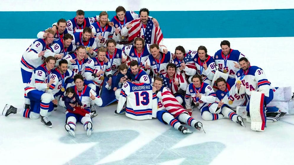 The US team poses for the cameras after the Olympic victory. Johnny Gaudreau's children are also there.