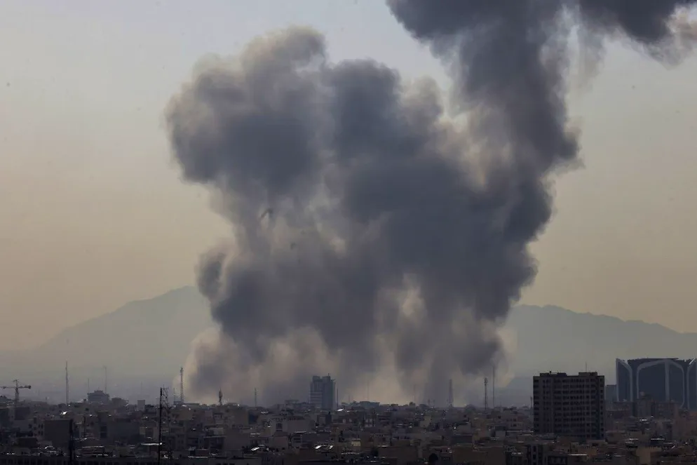 A plume of smoke rises following a reported explosion in Tehran on February 28, 2026. Two loud blasts were heard in Tehran on February 28 morning by AFP journalists, and two plumes of thick smoke were seen over the centre and east of the Iranian capital. Israel's defence ministry announced it had launched a "preemptive strike" on Iran as sirens sounded in Jerusalem and people across the country received phone alerts about an "extremely serious" threat. (Photo by ATTA KENARE / AFP)