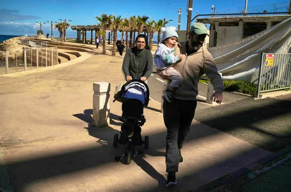 USA and Israel attack Iran. A couple with their two children rush into a shelter in Haifa after a warning siren sounded following Israeli attacks on Iran.