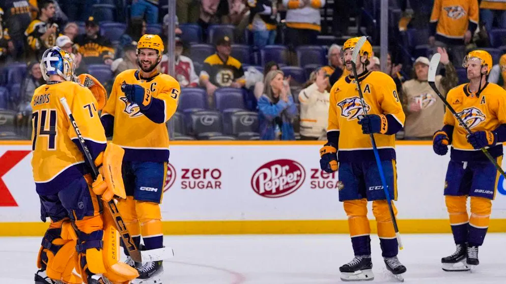 Nashville captain Roman Josi high-fives goalie Juuse Saros.