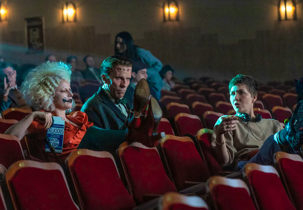 The Bride!. Director Maggie Gyllenhaal with her monsters while filming in a movie theater.