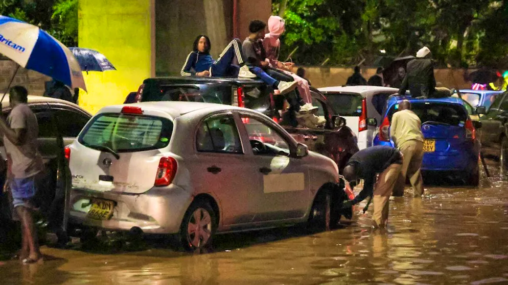 dpatopbilder - People climb on top of their cars after heavy rains flooded the streets in Nairobi. Photo: Andrew Kasuku/AP/dpa