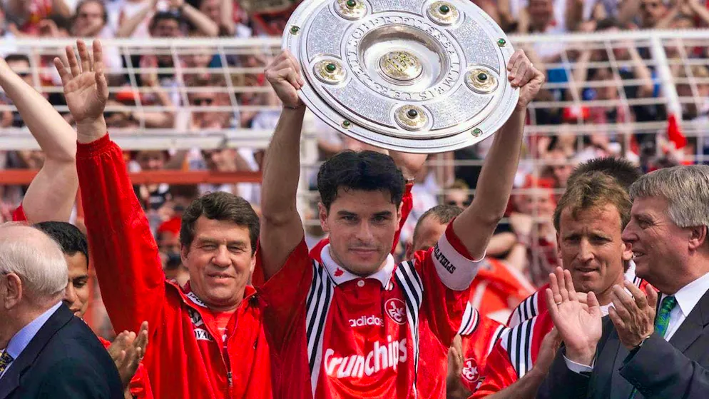 Lautern captain Ciriaco Sforza holds the championship trophy.