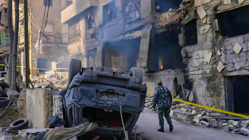 A man in uniform checks the damage caused by an Israeli airstrike on a building in the center of the city. Photo: Hussein Malla/AP/dpa