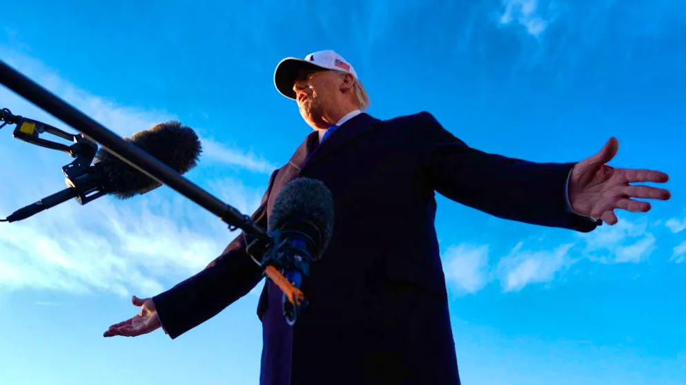 US President Donald Trump speaks to reporters before boarding Air Force One at Joint Base Andrews for a trip to Florida. Photo: Mark Schiefelbein/AP/dpa
