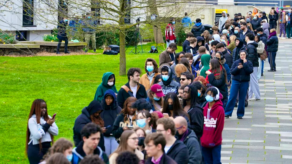 Students at the University of Kent queue up to receive antibiotics as a precaution.