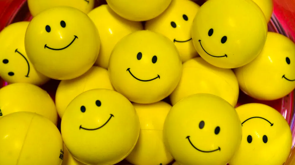 ARCHIVE - Yellow plastic balls with smileys printed on them. Photo: Martin Schutt/dpa-Zentralbild/dpa