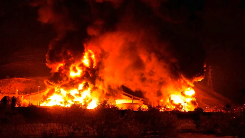 ARCHIVE - Flames rise from an oil storage facility after it was presumably hit by an Israeli missile. Photo: Vahid Salemi/AP/dpa