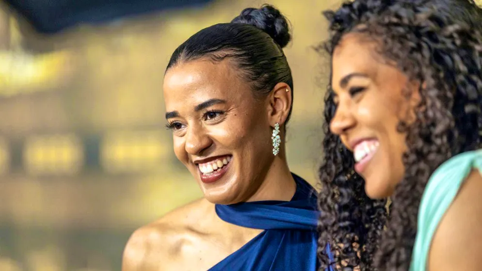 Between hurdle and needle: a dress runs with you - Gallery. Ditaji and Mujinga smile for the cameras