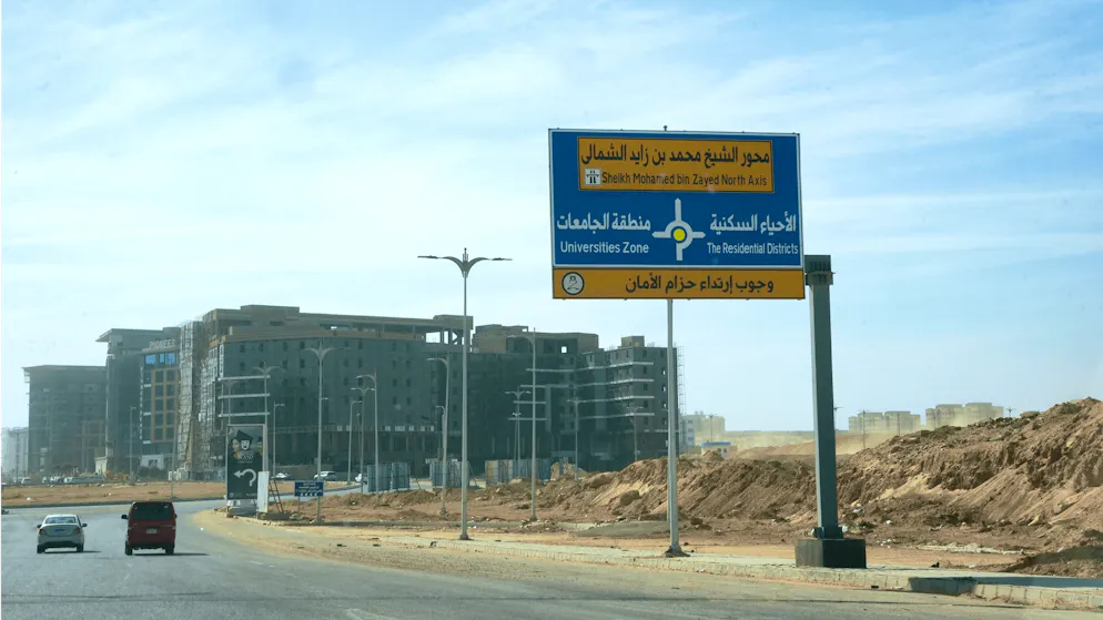 New Capital City_Picture gallery 1. The orientation is clear: wide streets, huge signs. But there are still gaps between the neighborhoods - a lot of desert, a lot of undeveloped land.